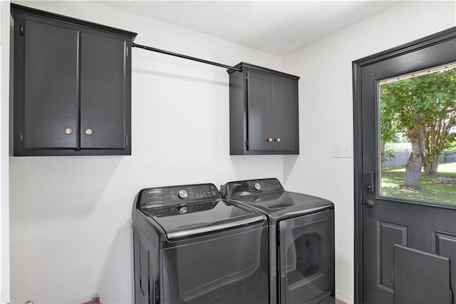 13310 August Dr, Mobile, AL 36695 - clothes washing area featuring washing machine and dryer, cabinet space, and healthy amount of natural light