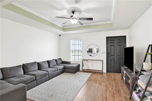 13310 August Dr, Mobile, AL 36695 - living area with a raised ceiling, wood finished floors, ceiling fan, ornamental molding, and baseboards