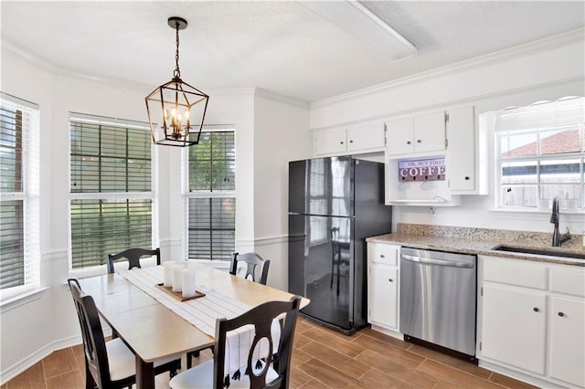 13310 August Dr, Mobile, AL 36695 - kitchen with dishwasher, a sink, freestanding refrigerator, a chandelier, and plenty of natural light