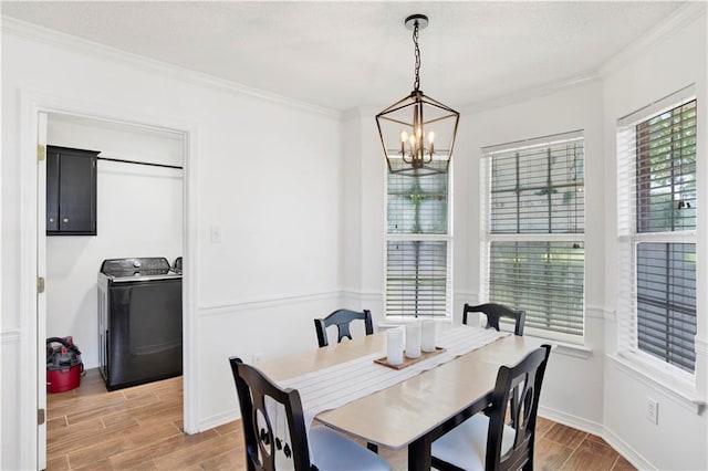 13310 August Dr, Mobile, AL 36695 - dining area with washer / dryer, wood tiled floors, ornamental molding, a chandelier, and baseboards