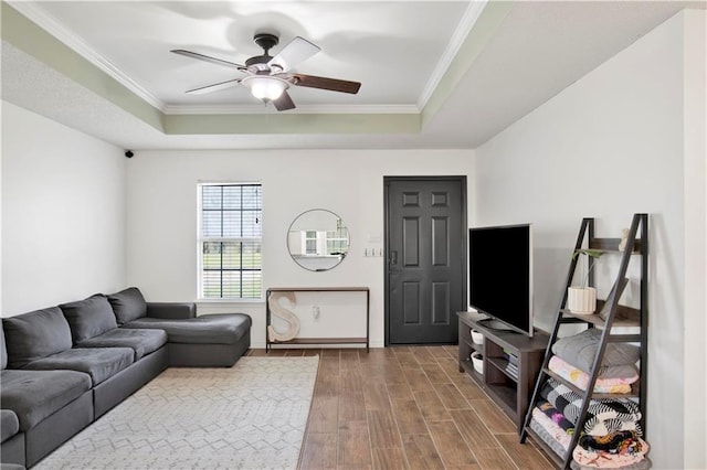 13310 August Dr, Mobile, AL 36695 - living area with a tray ceiling, ceiling fan, wood finished floors, crown molding, and baseboards