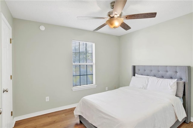 13310 August Dr, Mobile, AL 36695 - bedroom featuring wood finished floors, baseboards, a ceiling fan, and a textured ceiling