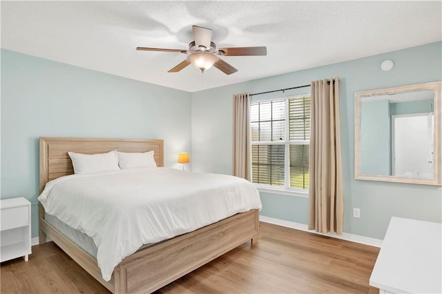 13310 August Dr, Mobile, AL 36695 - bedroom featuring baseboards, light wood-style floors, and a ceiling fan