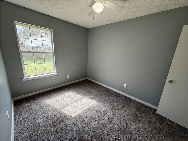 carpeted spare room with ceiling fan, baseboards, and a textured ceiling