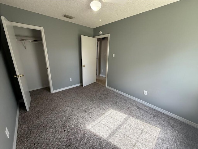 unfurnished bedroom with carpet, baseboards, visible vents, a closet, and a textured ceiling