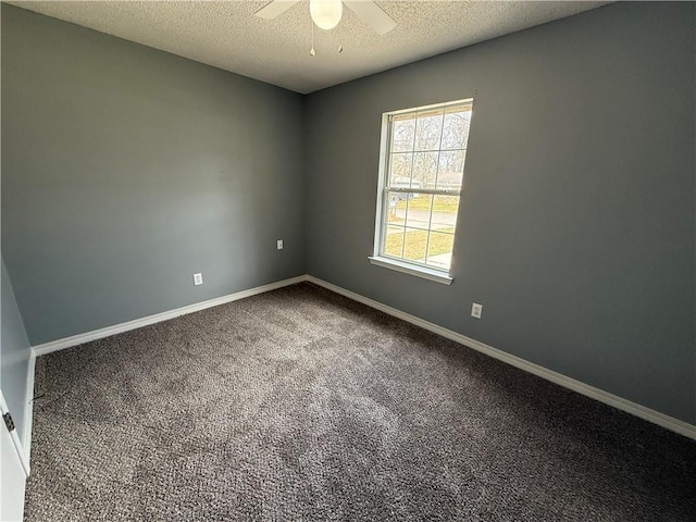 spare room with baseboards, carpet, ceiling fan, and a textured ceiling