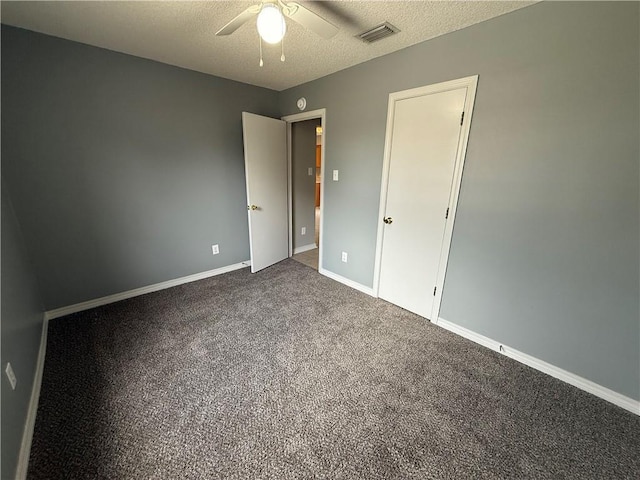 unfurnished bedroom featuring a ceiling fan, baseboards, visible vents, carpet floors, and a textured ceiling