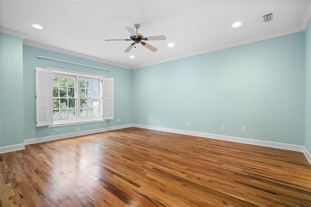 empty room with hardwood / wood-style flooring, ceiling fan, and ornamental molding