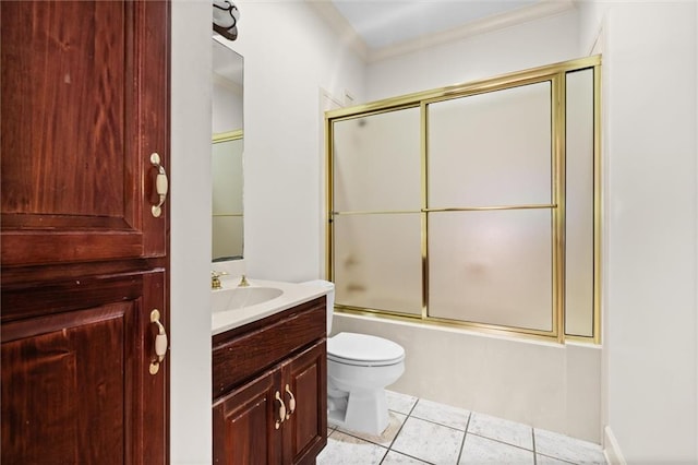 full bathroom with vanity, bath / shower combo with glass door, crown molding, tile patterned flooring, and toilet