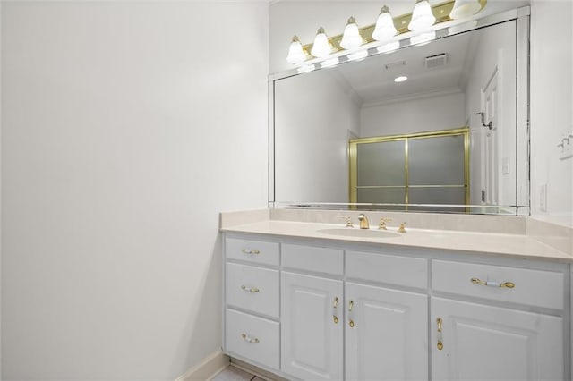 bathroom featuring vanity, crown molding, and walk in shower