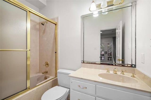 full bathroom with shower / bath combination with glass door, vanity, and toilet