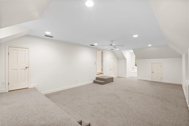 additional living space featuring light carpet, ceiling fan, and lofted ceiling