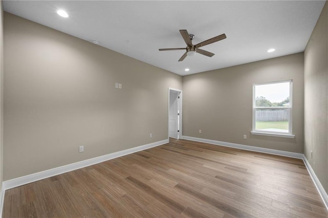 empty room featuring baseboards, wood finished floors, recessed lighting, and a ceiling fan