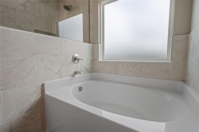 full bath with tile walls and a bath