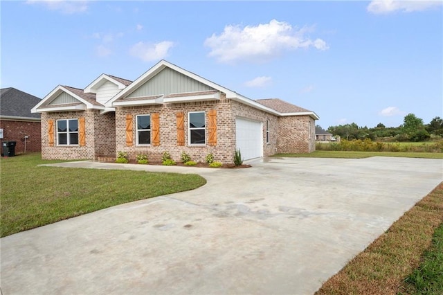 view of front of property with driveway, brick siding, a garage, and a front yard