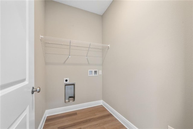 clothes washing area with baseboards, hookup for an electric dryer, laundry area, and hookup for a washing machine