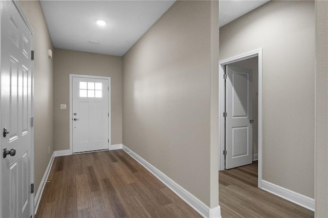 entryway featuring dark wood-type flooring and baseboards