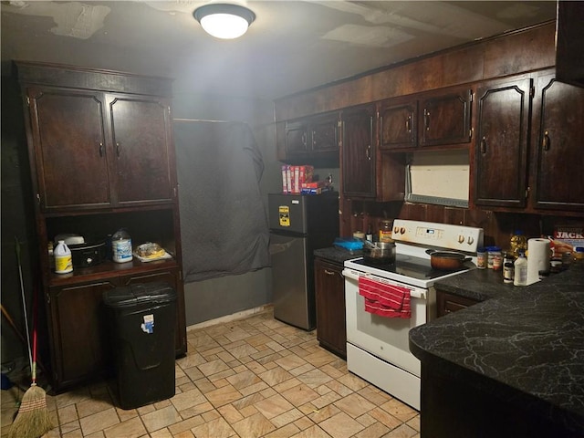 641 Baldwin Dr, Mobile, AL 36610 - kitchen featuring white range with electric cooktop, freestanding refrigerator, dark brown cabinets, dark countertops, and light stone finish flooring