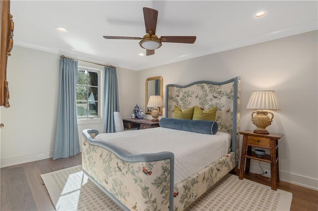 bedroom with crown molding, wood-type flooring, and ceiling fan