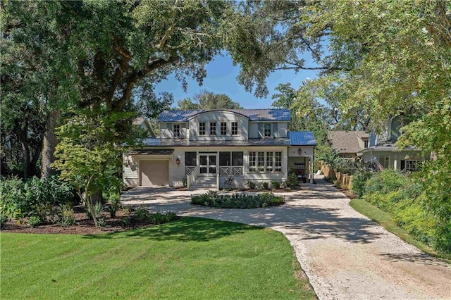 view of front facade with a front yard and a garage