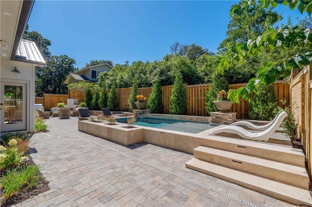 view of pool with a patio and a jacuzzi