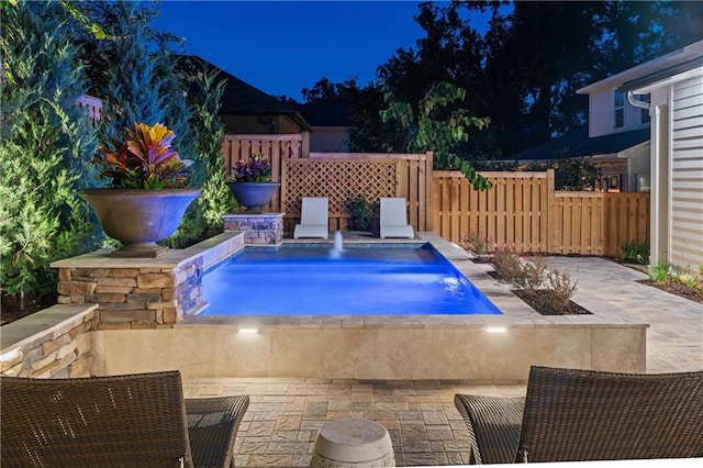 view of swimming pool with pool water feature and a patio