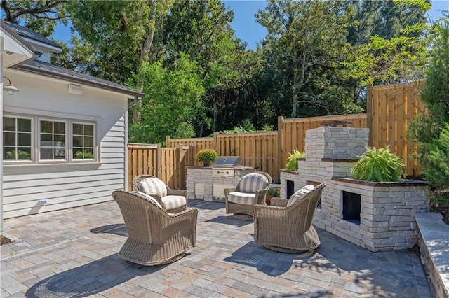 view of patio featuring an outdoor kitchen and a grill