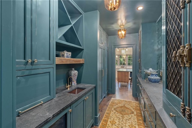 interior space featuring an inviting chandelier, sink, and dark wood-type flooring