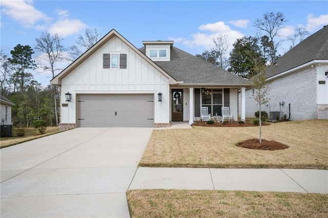 view of front of property with driveway, roof with shingles, central air condition unit, a front lawn, and board and batten siding