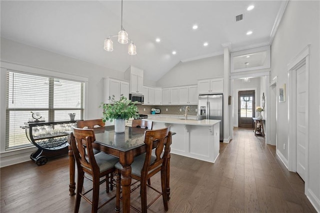 dining area featuring recessed lighting, visible vents, baseboards, ornamental molding, and dark wood finished floors