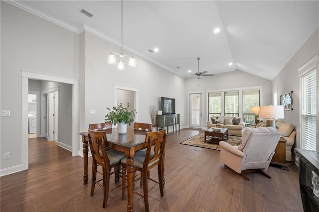 dining room with high vaulted ceiling, baseboards, visible vents, and wood finished floors