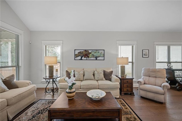 living room featuring lofted ceiling, baseboards, and wood finished floors