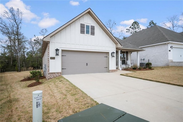 view of front of property featuring a garage, concrete driveway, a porch, board and batten siding, and a front yard