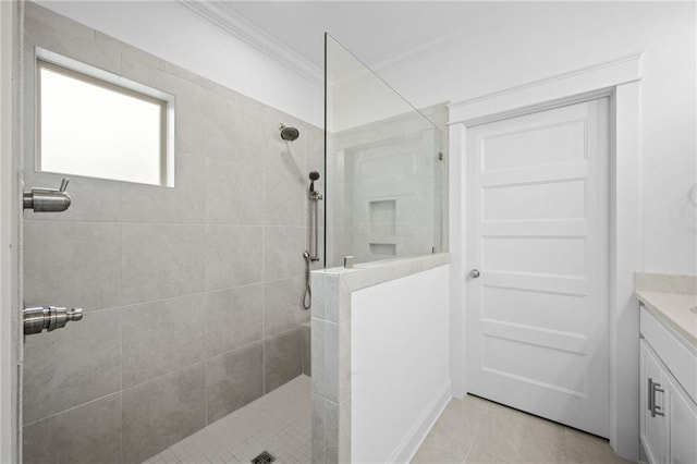 full bathroom with tile patterned flooring, walk in shower, crown molding, and vanity