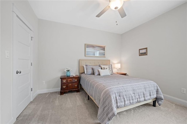 bedroom with ceiling fan, baseboards, and carpet flooring