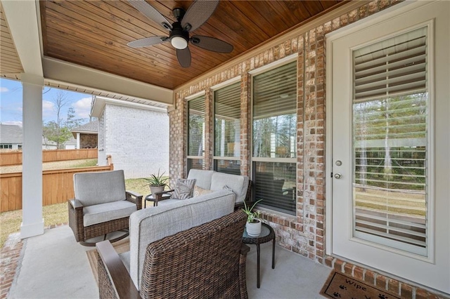 view of patio featuring outdoor lounge area, fence, and a ceiling fan