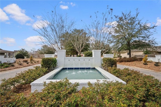 view of swimming pool featuring fence