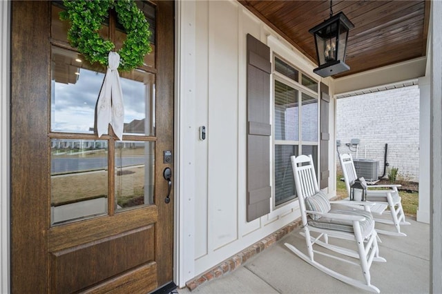 property entrance featuring a porch and cooling unit