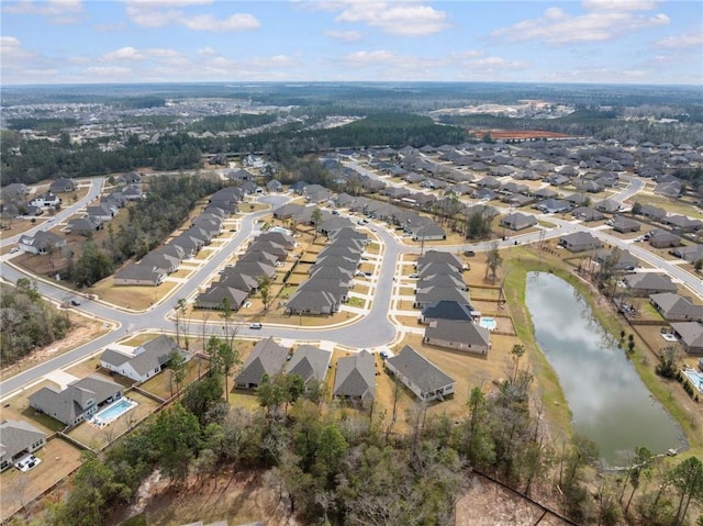 drone / aerial view featuring a residential view and a water view