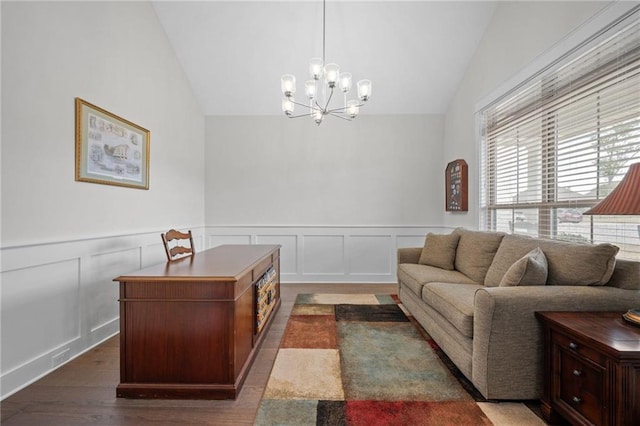 interior space featuring an inviting chandelier, vaulted ceiling, dark wood-style flooring, and a wainscoted wall