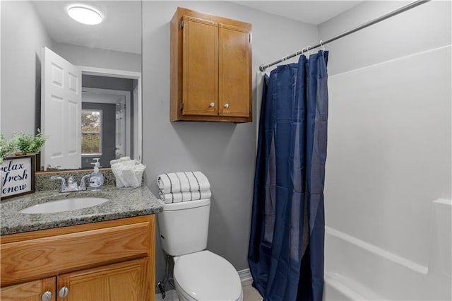 full bathroom featuring toilet, shower / bathtub combination with curtain, and vanity