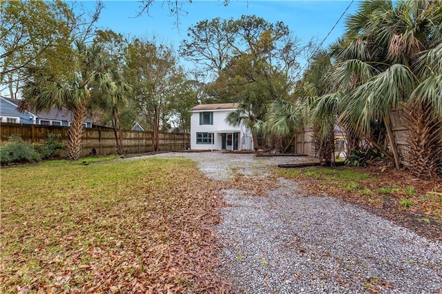 exterior space featuring a fenced backyard and a yard