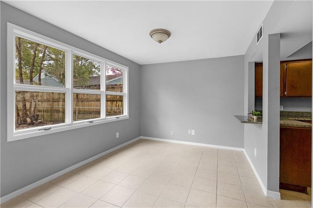 unfurnished room featuring visible vents, baseboards, and light tile patterned flooring