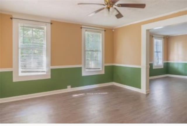 unfurnished room with hardwood / wood-style flooring and ceiling fan