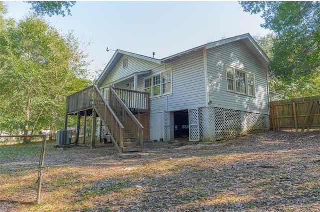 back of property with a deck and central air condition unit