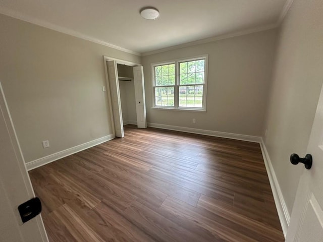 3050 Lacoste Rd, Mobile, AL 36618 - unfurnished bedroom featuring ornamental molding, dark wood-style flooring, baseboards, and a closet