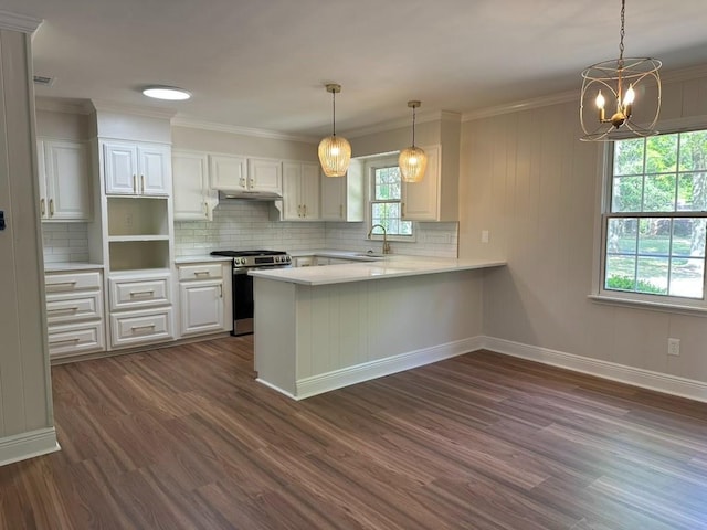 3050 Lacoste Rd, Mobile, AL 36618 - kitchen with stainless steel gas stove, dark wood-style floors, a peninsula, tasteful backsplash, and crown molding