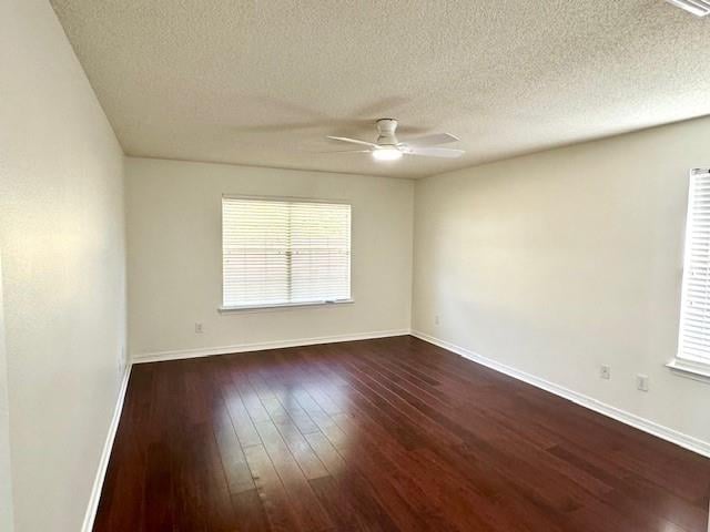 spare room featuring ceiling fan, dark hardwood / wood-style flooring, and a textured ceiling