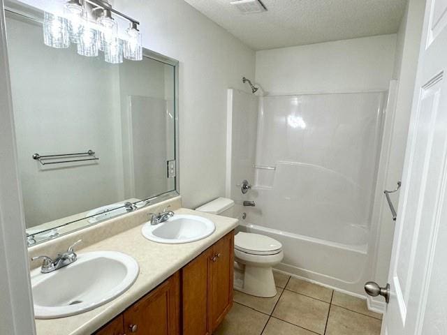 full bathroom with vanity,  shower combination, toilet, tile patterned floors, and a textured ceiling