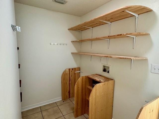 laundry room with hookup for a washing machine and light tile patterned flooring